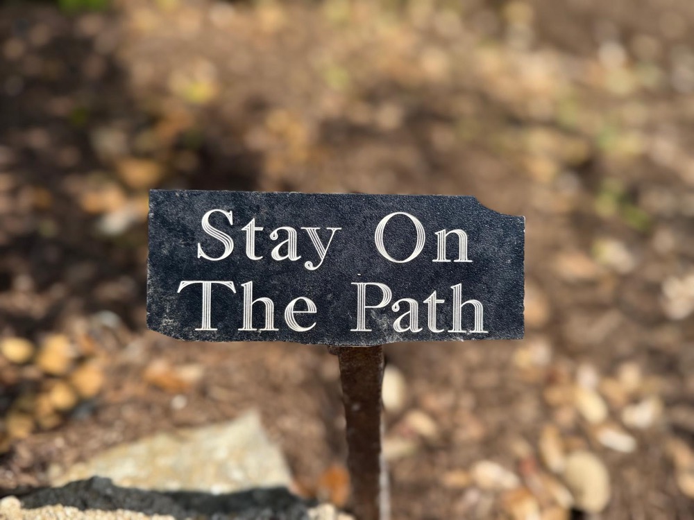 Sign reading Stay On The Path